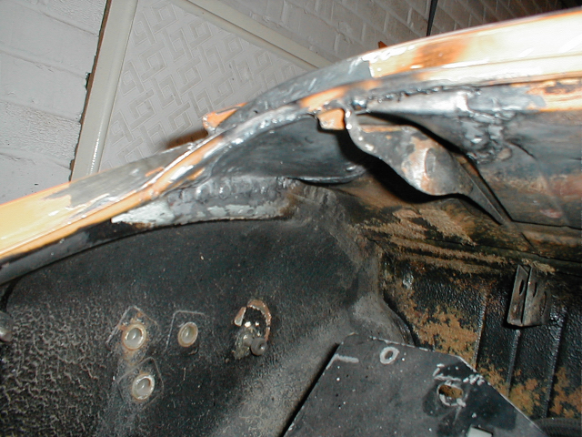 Poor picture, but this shows the engine lid hinge back in place