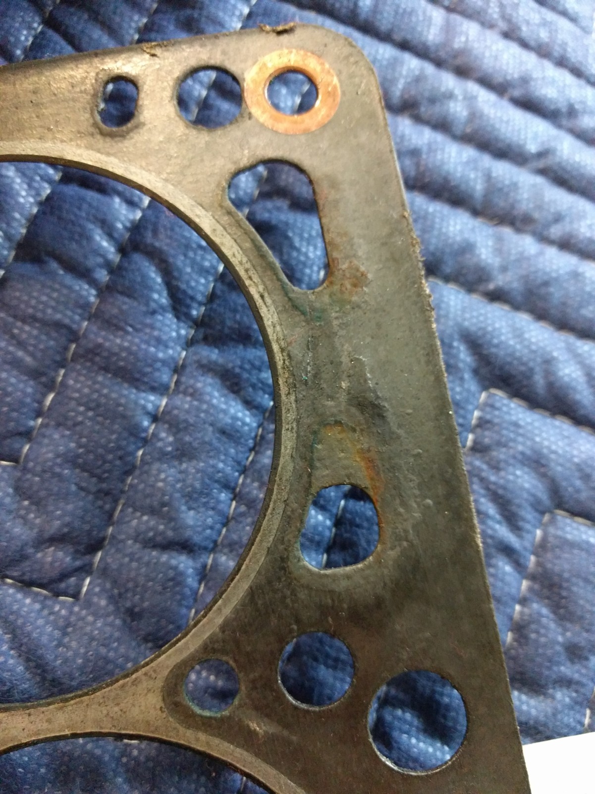 Gasket shows signs of water/corrosion around damaged water jackets.