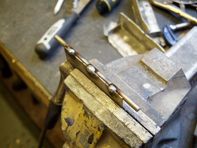 Welding the trap doors to the hinge pin